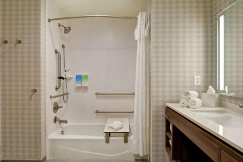 a bathroom with a tub and a sink and a shower at Home2 Suites Charleston West Ashley in Charleston