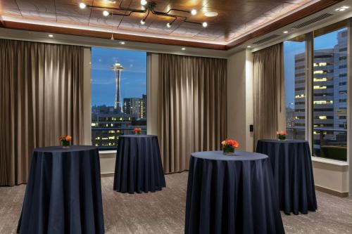 a conference room with tables and a view of the space needle at The Sound Hotel Seattle Belltown, Tapestry Collection in Seattle