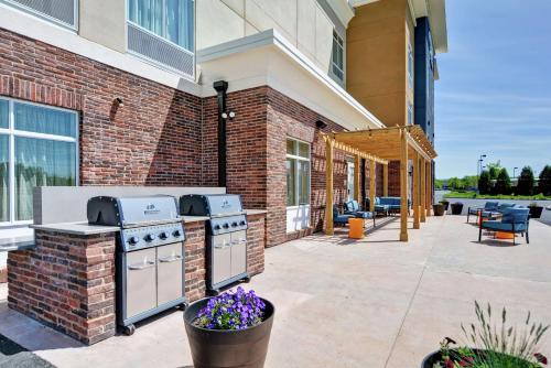 a outdoor patio with a grill and a brick building at Homewood Suites By Hilton Hadley Amherst in Hadley