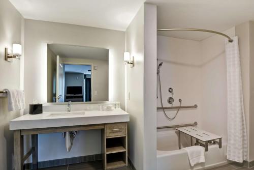 a white bathroom with a sink and a shower at Homewood Suites By Hilton Hadley Amherst in Hadley