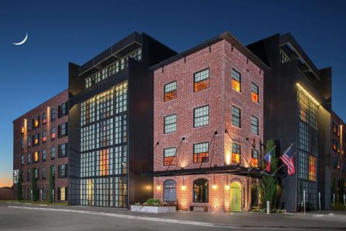 a large brick building with a moon in the sky at NYLO Las Colinas Hotel, Tapestry Collection by Hilton in Irving
