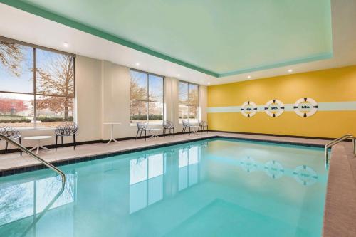 una piscina con sillas y mesas en una habitación de hotel en Tru By Hilton Greenville Woodruff Road, SC en Greenville