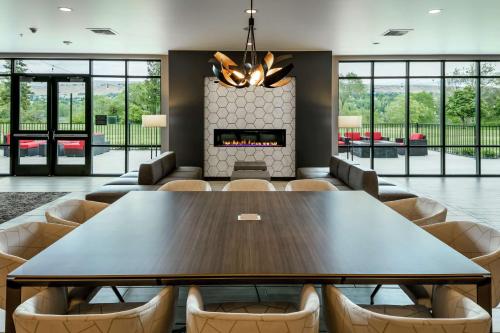 a dining room with a table and chairs and a fireplace at Hilton Garden Inn Wenatchee, Wa in Wenatchee