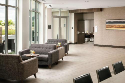 a lobby with couches and chairs and a table at Hilton Garden Inn Sacramento Airport Natomas in Sacramento