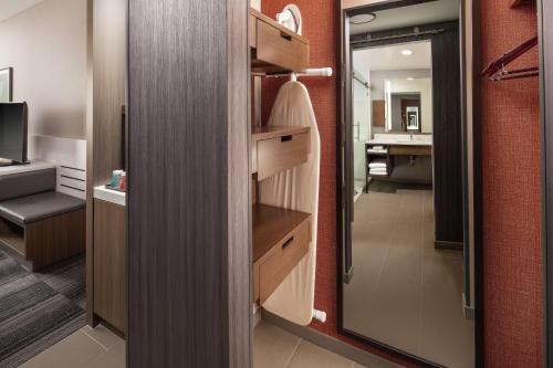 a room with a bathroom with a sink and a mirror at Hilton Garden Inn Sacramento Airport Natomas in Sacramento
