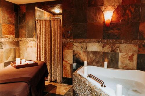 a bathroom with a bath tub in a room at Chrysalis Inn & Spa Bellingham, Curio Collection by Hilton in Bellingham