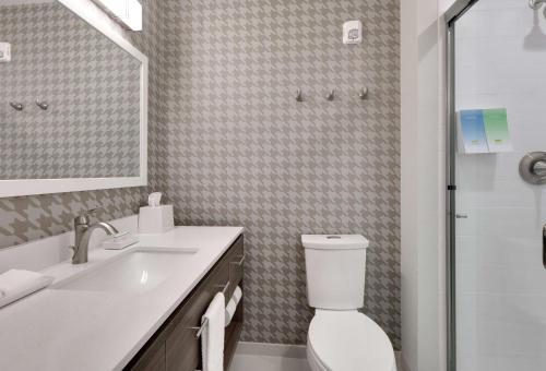 a bathroom with a toilet and a sink and a shower at Home2 Suites By Hilton Yakima Airport in Yakima