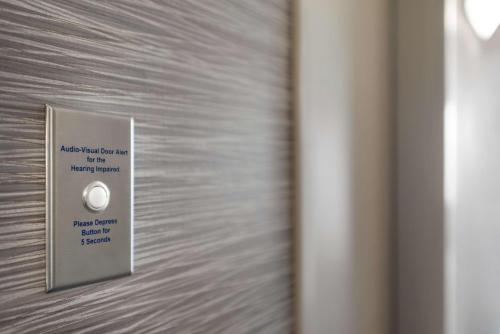 a metal door with a sign on it at Home2 Suites By Hilton Overland Park, Ks in Overland Park