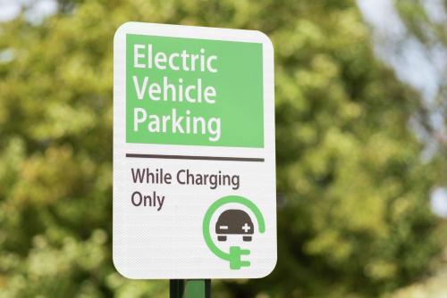a sign for electric vehicle parking in a park at Home2 Suites By Hilton Overland Park, Ks in Overland Park