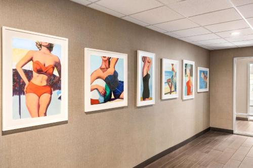 a group of pictures on a wall in a room at Hampton Inn & Suites Ocean City West in Ocean City