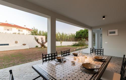 a dining table on the patio of a house at Casa As Macieiras in Bolembre de Baixo