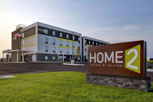 a sign in front of a building at Home2 Suites By Hilton Loves Park Rockford in Loves Park