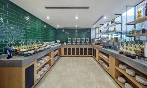 a restaurant with green tile walls and a counter at Doubletree By Hilton Afyonkarahisar in Afyon