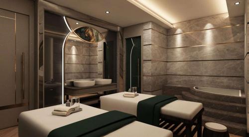a bathroom with two beds and a bath tub at Doubletree By Hilton Afyonkarahisar in Afyon