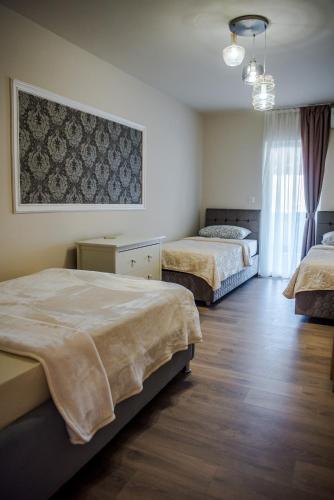 a bedroom with two beds and a painting on the wall at Apartment Domenica Medjugorje in Međugorje