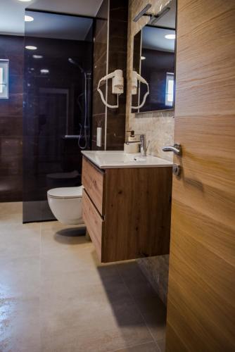 a bathroom with a sink and a toilet and a mirror at Apartment Domenica Medjugorje in Međugorje