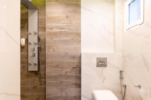 a bathroom with a shower and a toilet and a sink at Hotel Samaras Beach in Limenaria
