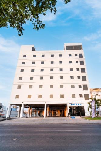 a white building with a lot of windows at Hotel Pacific Blue Mazatlan in Mazatlán