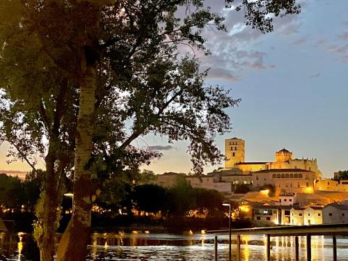 a view of a city at night with a castle at In Love Zamora in Zamora