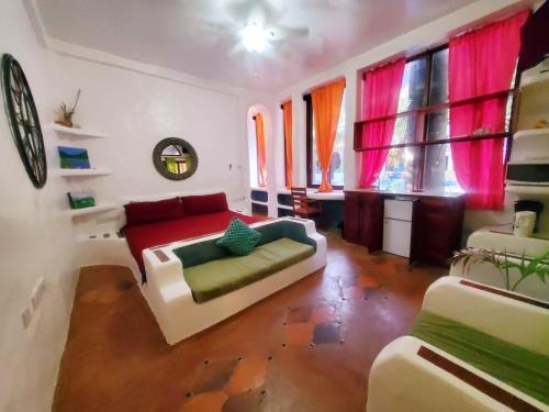 a living room with a couch and some windows at Reef View Pavilions - Villas & Condos in Lance aux Épines