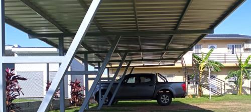 a truck is parked under a metal roof at Las Casuarinas in Federación
