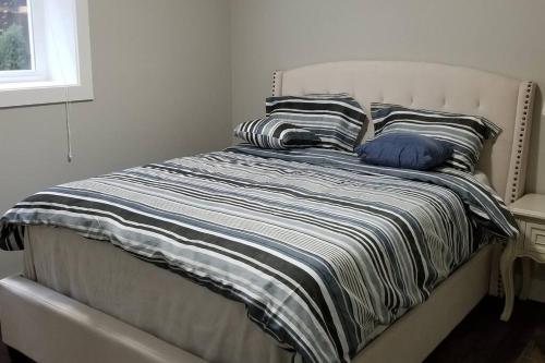 A bed or beds in a room at Spacious Basement Suite(Brand New) Self-contained