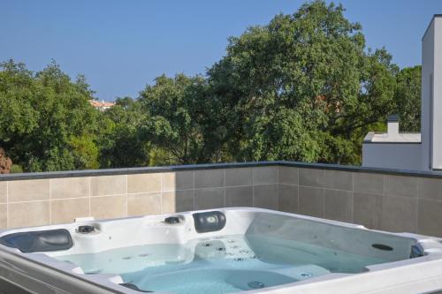 a bath tub sitting on top of a house at Villa Luz 37 - Jacuzzi Terrace & Swimming Pool in Albufeira