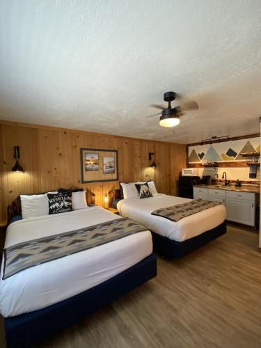 a hotel room with two beds and a kitchen at Columbia Point Resort in Kettle Falls