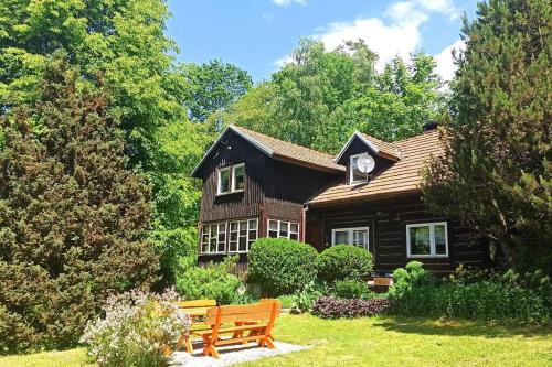 a wooden house with a bench in front of it at Trzemcha in Tuchów