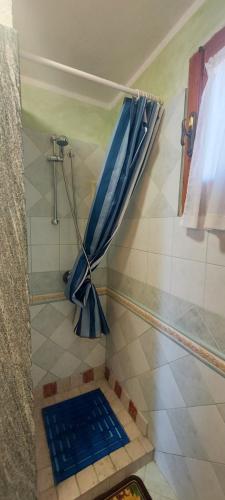 a shower with a blue umbrella in a bathroom at Bella Vista in Torre Dei Corsari