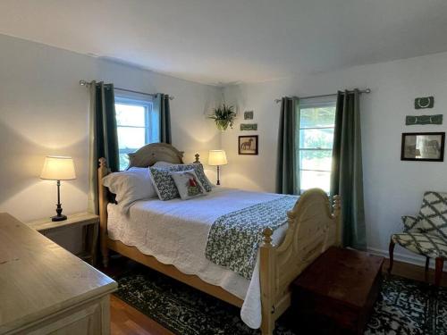 a bedroom with a bed and two windows at The Bourbon & Horse Country EpiCenter in Frankfort