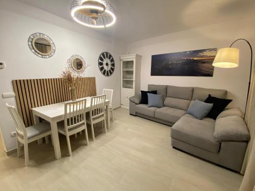 a living room with a couch and a table at APARTAMENTS L’ARC in Palafrugell