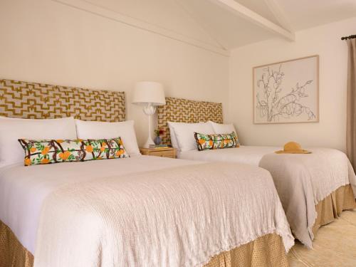 a bedroom with two beds with white sheets at Farmhouse Paso in Paso Robles