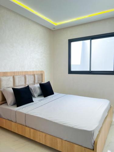 a bedroom with a large bed with a window at Royal Rif Alhoceima in Al Hoceïma