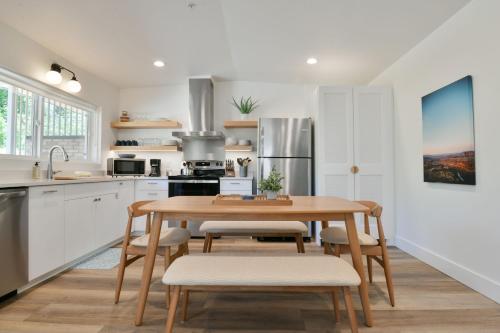 a kitchen with a wooden table and chairs in a kitchen at Moab Inn Towner #4 - Heart of Downtown in Moab