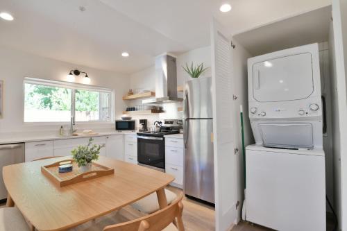 a kitchen with a table and a refrigerator at Moab Inn Towner #4 - Heart of Downtown in Moab