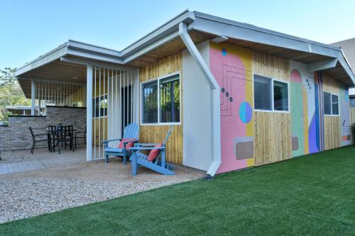 a colorful shed with a table and chairs on a lawn at Moab Inn Towner #4 - Heart of Downtown in Moab