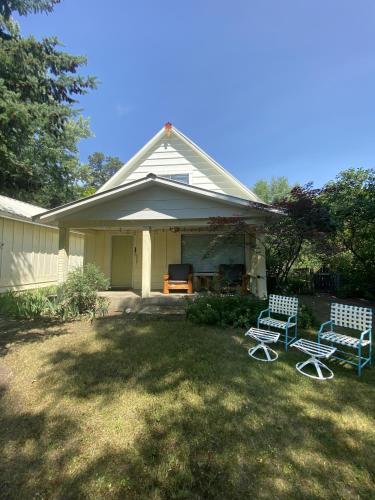 two chairs sitting in a yard in front of a house at Columbia Point Resort in Kettle Falls