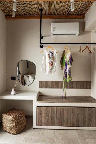 a dressing room with a mirror and a dressing table at Lithos Luxury Villa in Archangelos