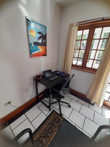 a room with a desk with a laptop on it at Montego Bay westgate Hills jamaica Melrose place in Montego Bay
