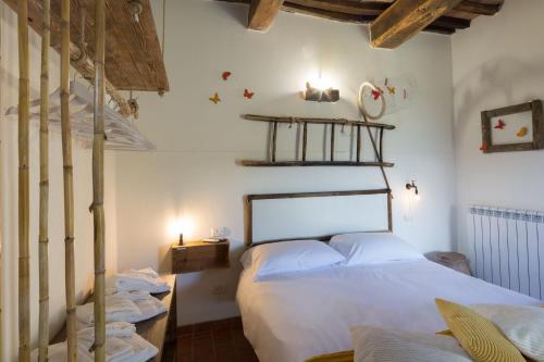 a bedroom with a white bed and a staircase at La Casa Di Campagna in Magione