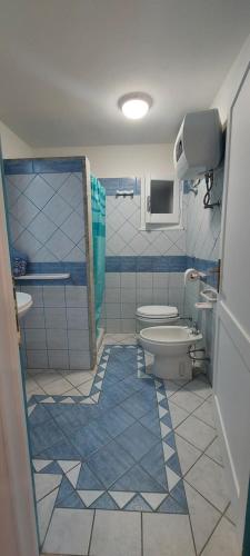 トッレ・デイ・コルサリにあるBella Vistaの青と白のバスルーム(トイレ、シンク付)
