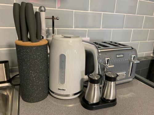 a kitchen counter with a toaster and utensils at The Whitehouse in Blackpool