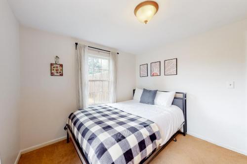 a bedroom with a bed with a checkered blanket at Mountain Haven Retreat in Granby