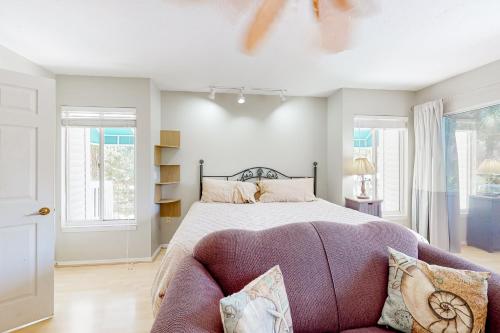 a bedroom with a large bed and a couch at Serene Siesta Key in Siesta Key