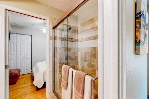 a bathroom with a shower and towels in it at Serene Siesta Key in Siesta Key