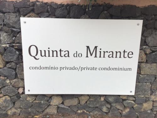 a sign on the side of a stone wall at Vivenda Moura, Caloura in Caloura