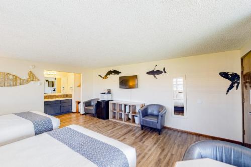 a hotel room with two beds and a kitchen at The Lamplighter Inn - Crab Shack and Whale Watching in Bandon