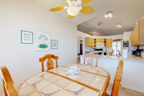 a dining room and kitchen with a table and chairs at Home West Escape in Oro Valley