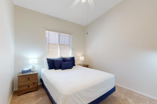 a bedroom with a large white bed and a window at Home West Escape in Oro Valley